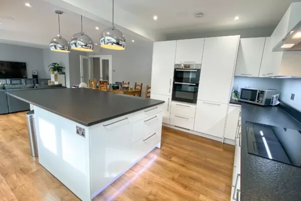 White U-Shaped Kitchen with Pendant Lighting
