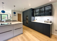 Elegant modern kitchen with matt grey cabinetry and a double oven.