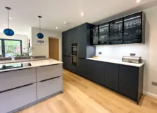 Elegant modern kitchen with matt grey cabinetry and a double oven.
