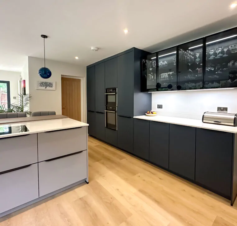 Elegant modern kitchen with matt grey cabinetry and a double oven.