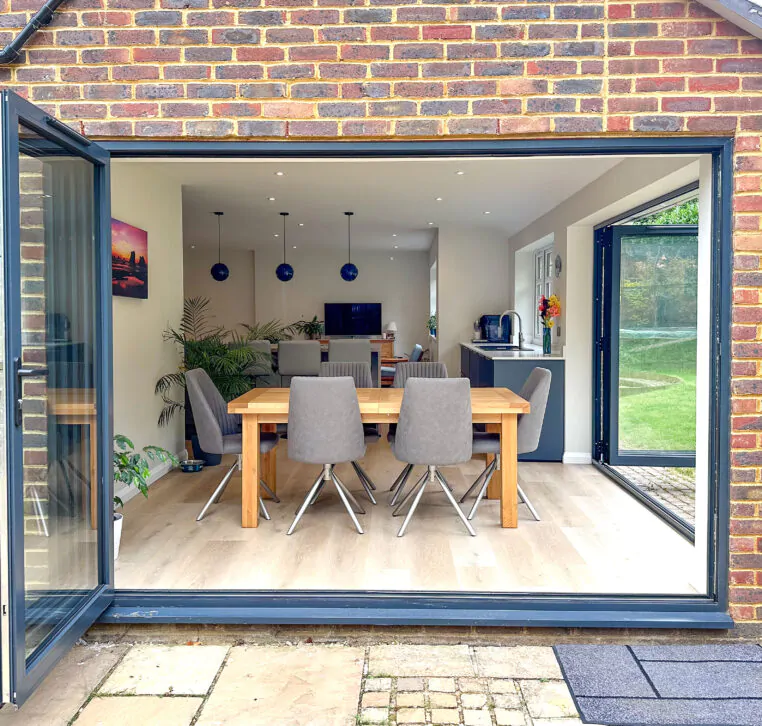 Bifold doors opening to the garden from a modern shaker kitchen with an island