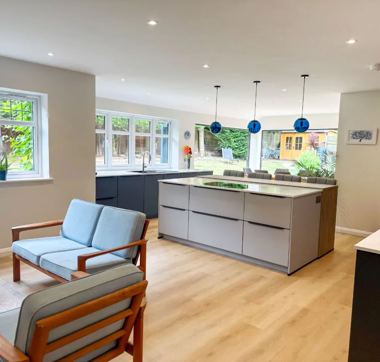 Modern open-plan kitchen with grey cabinets and a spacious island in the center