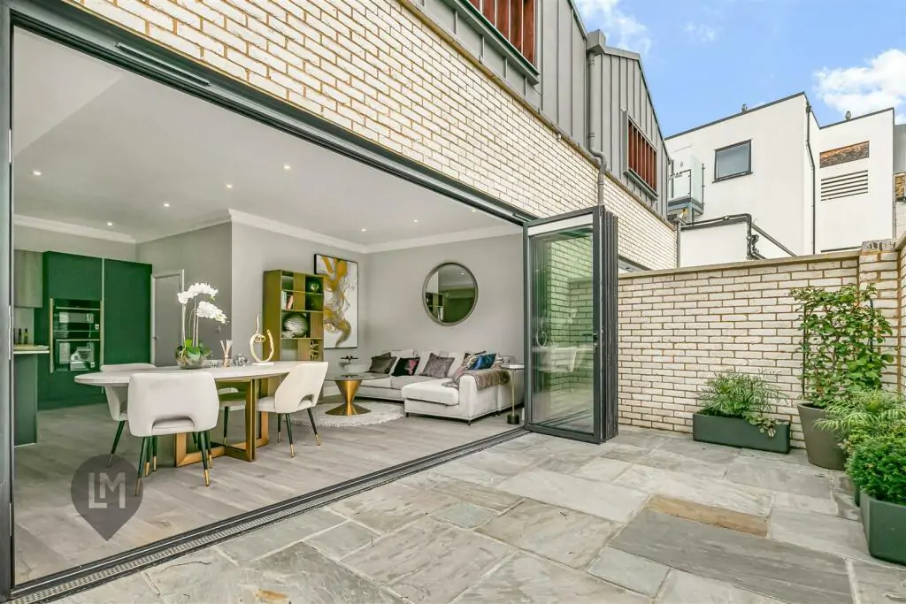 Indoor-outdoor living space featuring large sliding doors and contemporary design in a Camborne Mews home