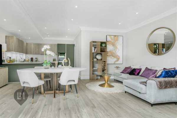 -plan living and dining area with stylish furnishings and light wood flooring in a 3-bed home at Camborne Mews, London
