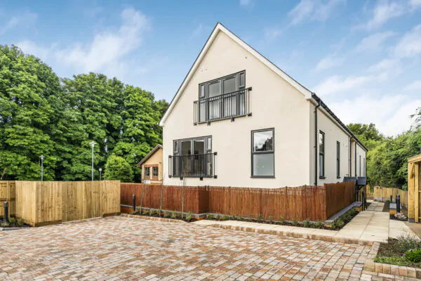 modern residential building in Alton with dual balconies and brick-paved driveway