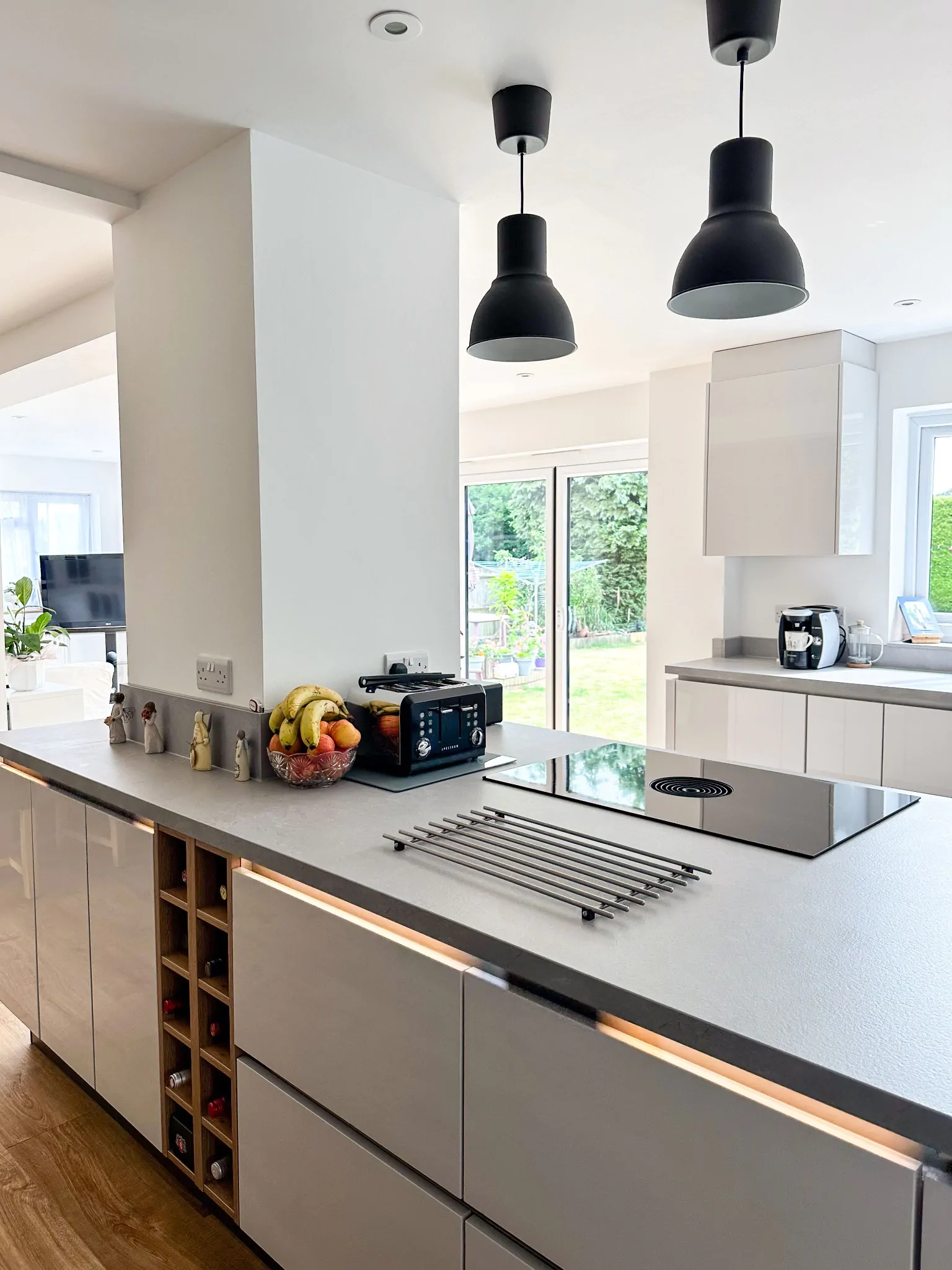 Close-up of a modern kitchen island featuring a sleek induction hob and black toaster