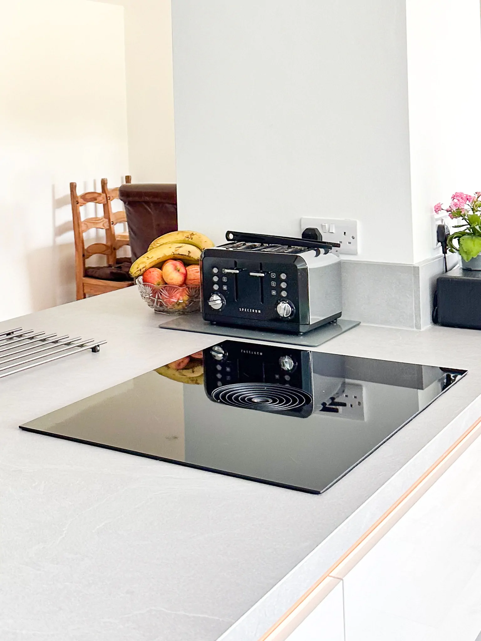 Kitchen island with a built-in wine rack, fruit bowl, and integrated appliances