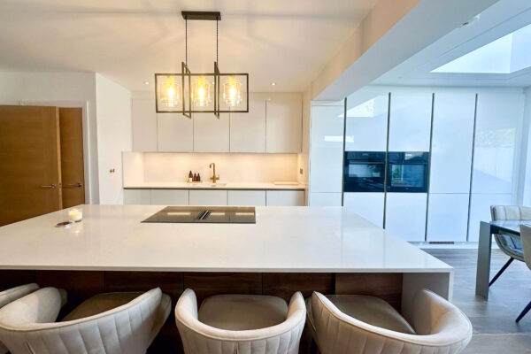 Minimalist White Gloss Kitchen with Sleek Island & Pendant Lighting