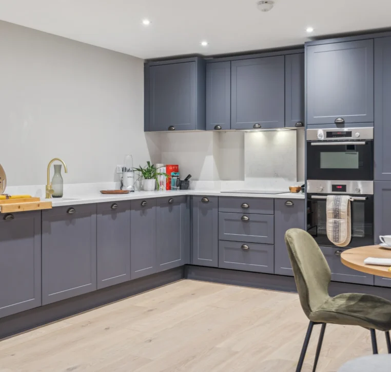 Fitted kitchen in residential development with modern lighting