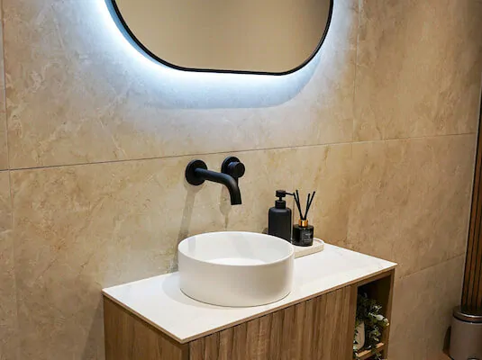 Bathroom vanity unit with countertop basin and wall-mounted tap.