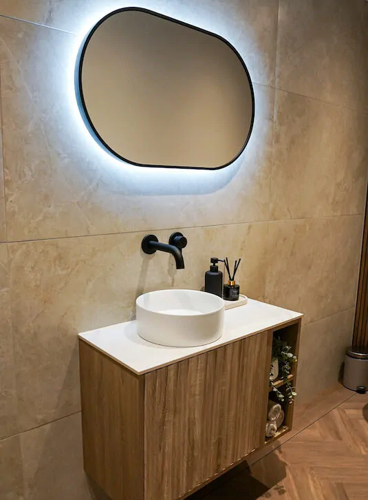 Bathroom vanity unit with countertop basin and wall-mounted tap.