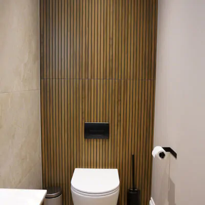 Bathroom WC set against a vertical slatted feature wall.