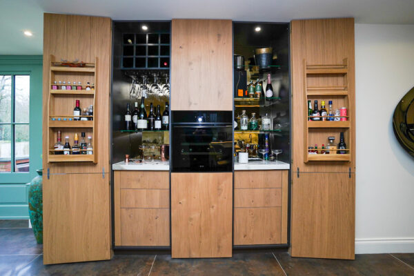 Bespoke oak home bar with wine storage and glass shelving.