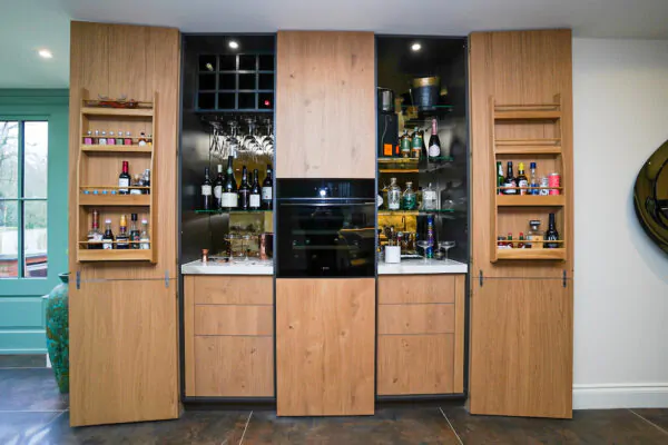 Bespoke oak home bar with wine storage and glass shelving.