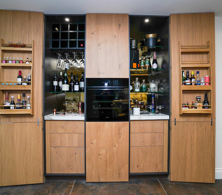 Bespoke oak home bar with wine storage and glass shelving.