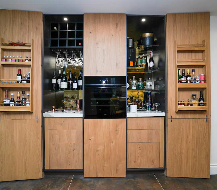 Bespoke oak home bar with wine storage and glass shelving.