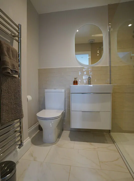 Compact bathroom with vanity unit, WC, and walk-in shower.