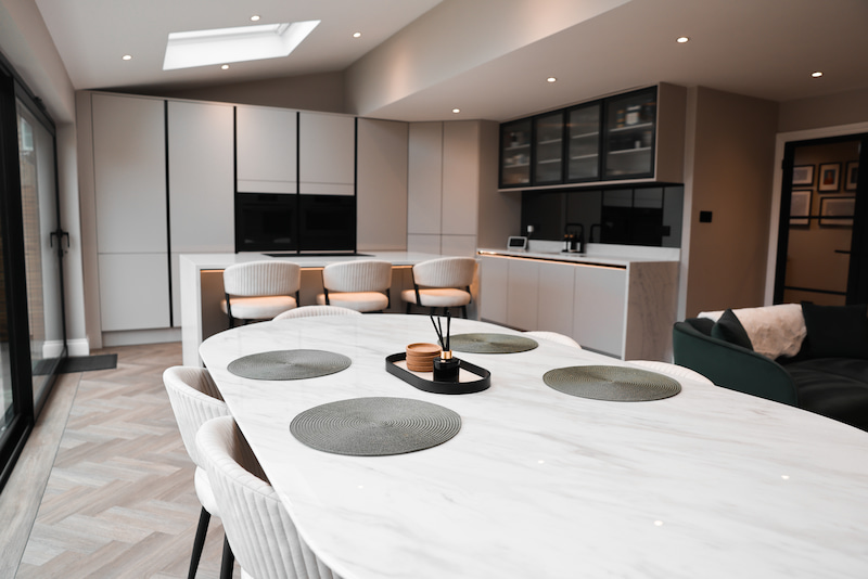 Kitchen island and dining area lit by skylights.