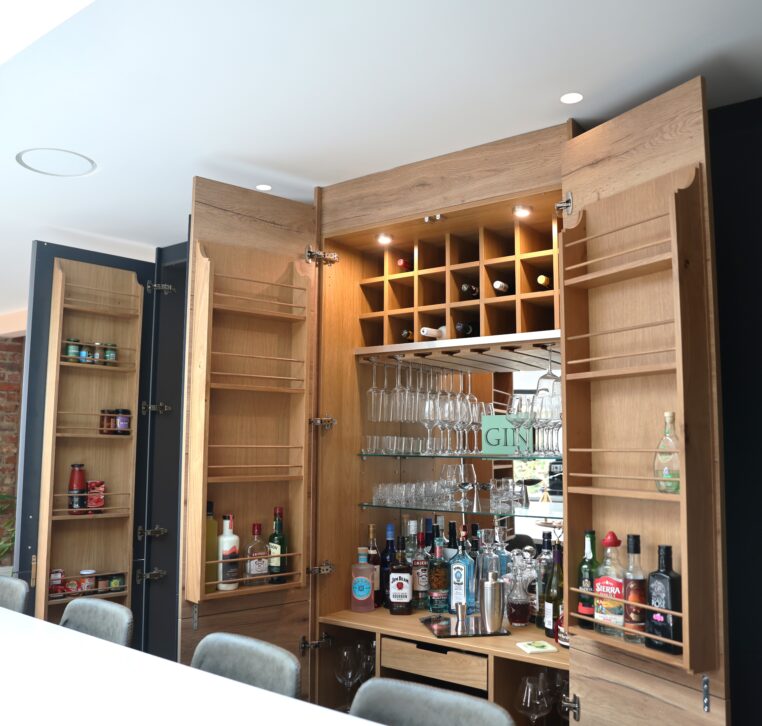 Bespoke kitchen drinks cabinet with built-in wine storage, glass holders and shelving