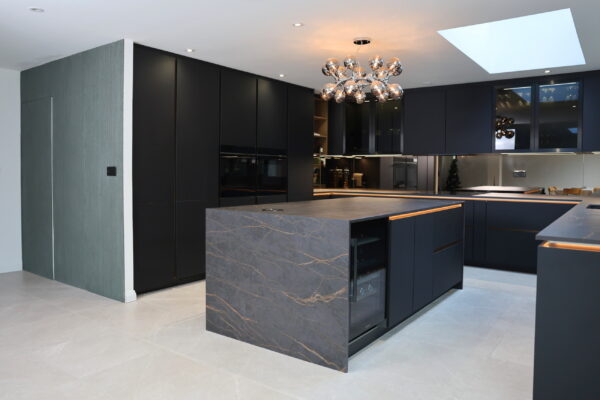 Modern kitchen island with stone worktop, dark cabinetry and integrated storage