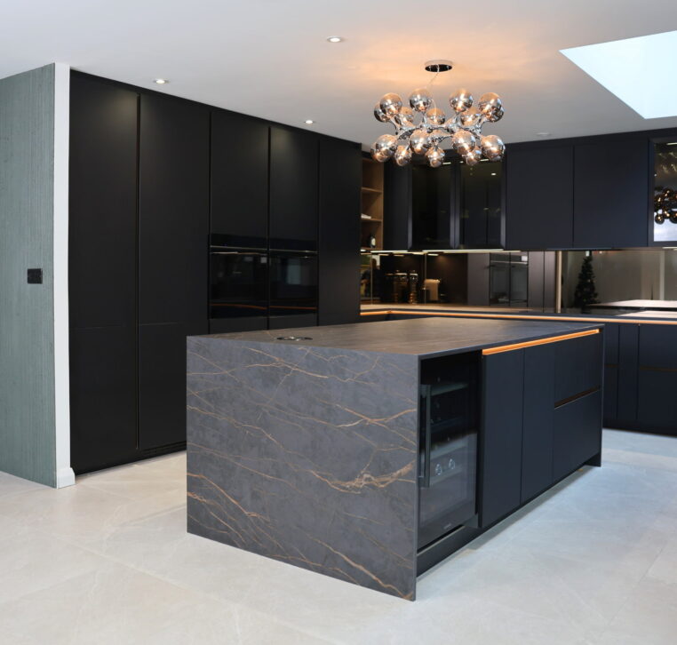 Modern kitchen island with stone worktop, dark cabinetry and integrated storage