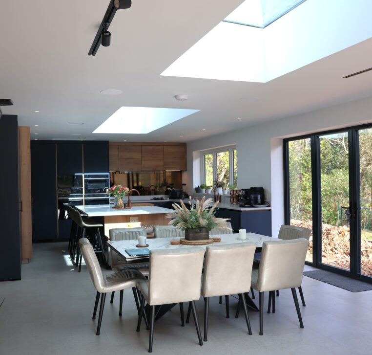 Spacious open plan kitchen with large skylights, bi-fold doors and modern island layout