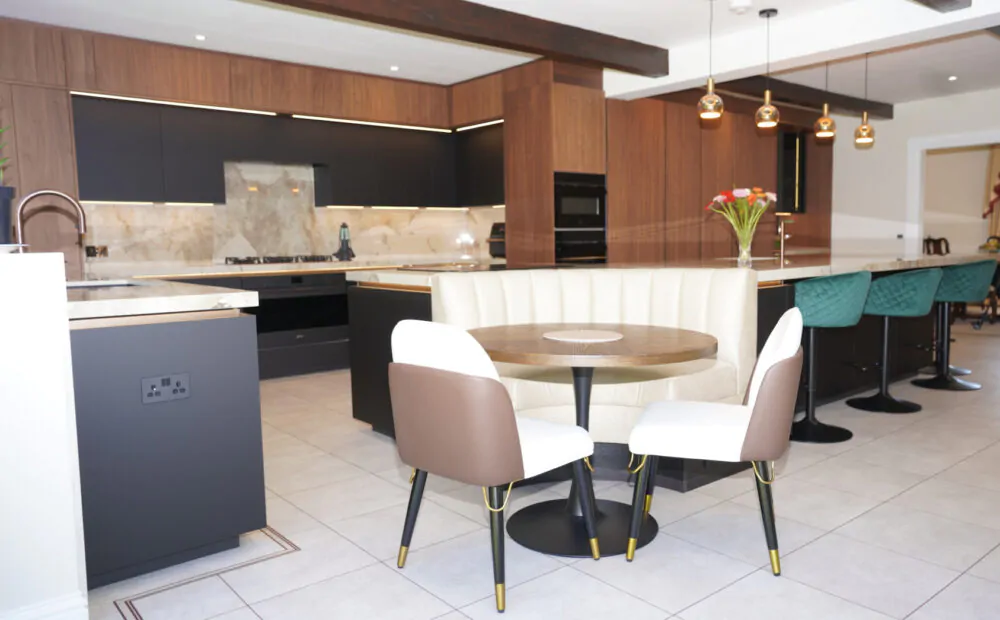 Handleless U-shaped kitchen with white cabinets and wood accents, completed by MAS Kuchen in Reading.