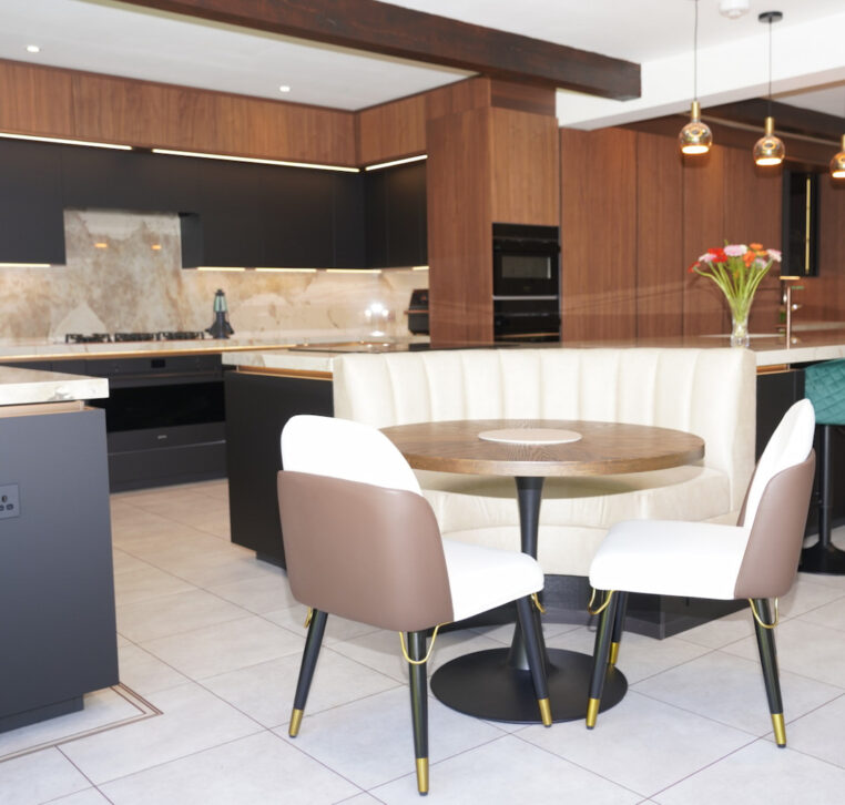 Handleless U-shaped kitchen with white cabinets and wood accents, completed by MAS Kuchen in Reading.