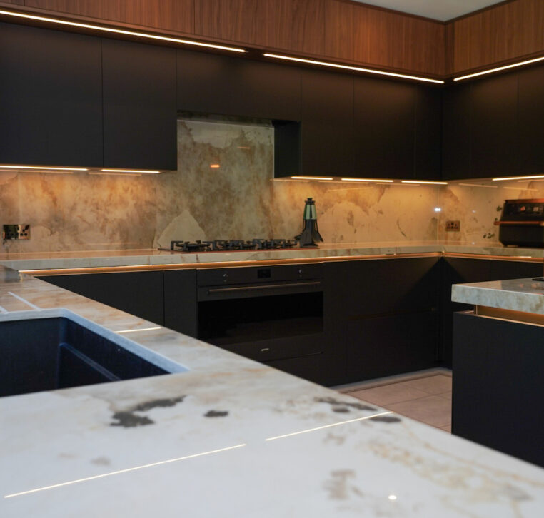Bespoke kitchen storage solutions with pull-out drawers and integrated appliances by MAS Kuchen.