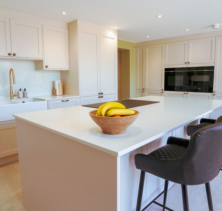 Luxury shaker kitchen with large island, integrated appliances and elegant neutral finishes by MAS Kuchen.