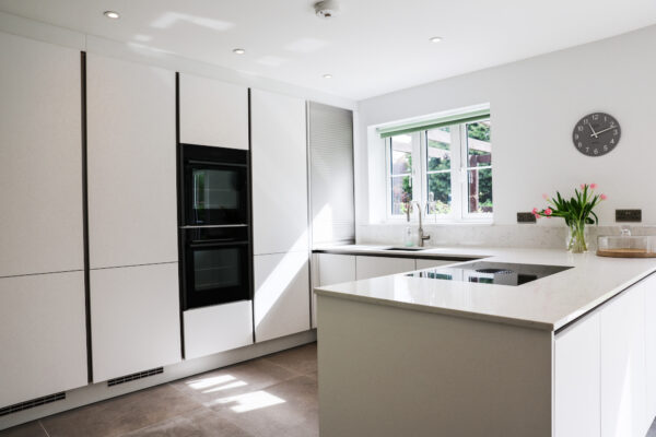 White Handleless Kitchen with Open-Plan Dining & Integrated Appliances
