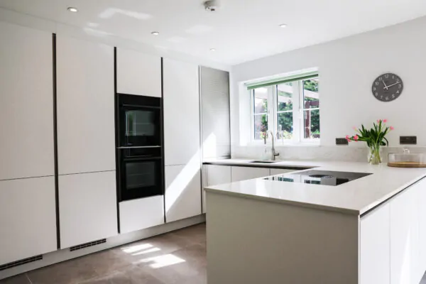 White Handleless Kitchen with Open-Plan Dining & Integrated Appliances